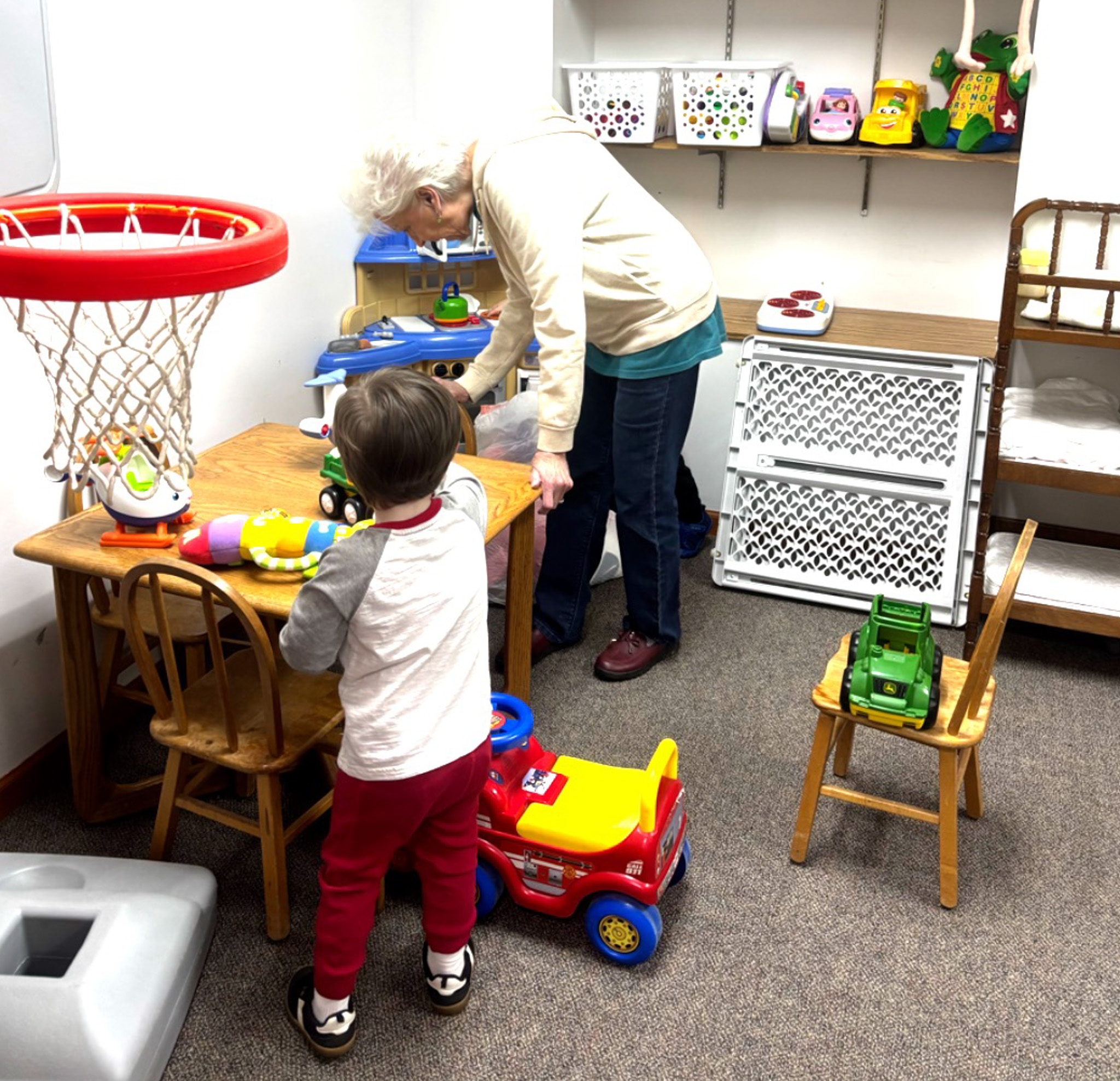 A child exploring toys in the Kids Ministry nursery room