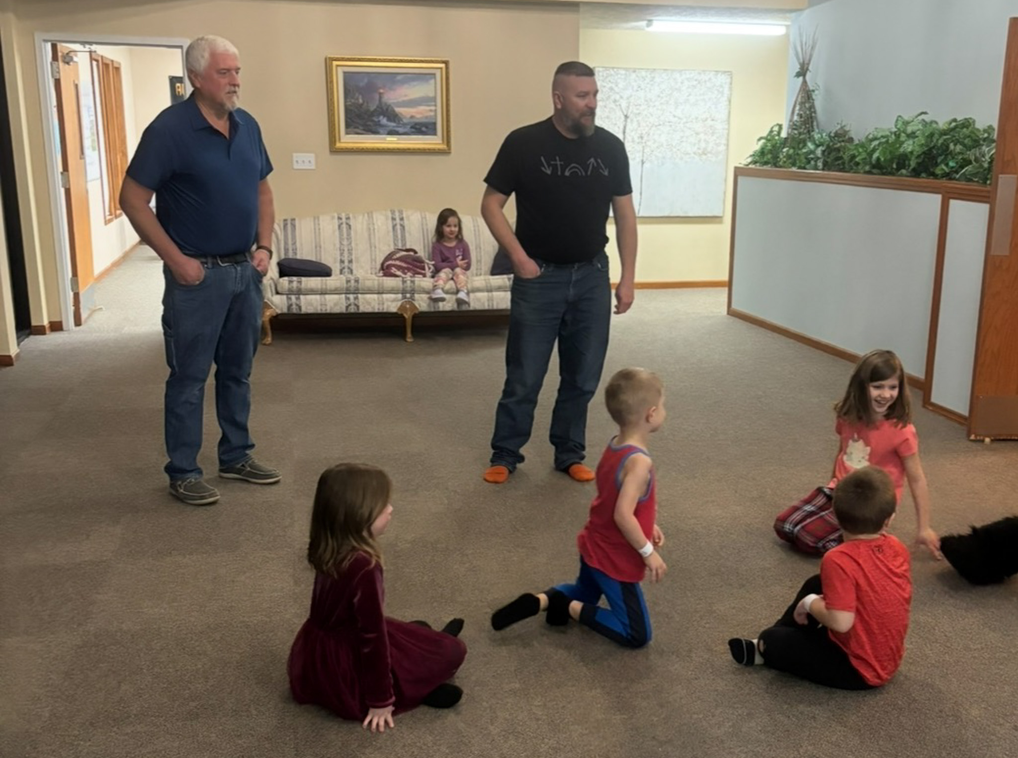 Kids Ministry fun in front of the painted Bible mural wall